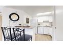 Bright kitchen with granite countertops and white appliances, adjacent to the living space at 8701 Huron St # 1-207, Thornton, CO 80260