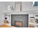 Close-up of a stylish fireplace with a black brick surround and decorative shelving, adding warmth and character at 1939 S Sherman St, Denver, CO 80210