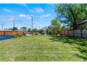Spacious backyard with lush lawn, fenced perimeter, and outdoor seating area at 1390 Emporia St, Aurora, CO 80010