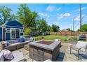 Landscaped backyard featuring a fire pit, patio furniture, and well-maintained lawn at 1390 Emporia St, Aurora, CO 80010