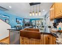 Modern kitchen featuring a copper sink, stainless steel appliances, and stylish pendant lighting at 876 Broken Lance Dr, Breckenridge, CO 80424