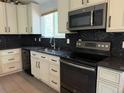 Updated kitchen, features dark granite countertops and stainless steel appliances at 4316 N Malta St, Denver, CO 80249