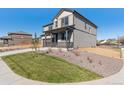 Home exterior showcasing landscaped front yard with stone mulch and manicured grass at 9882 Cathay St, Commerce City, CO 80022