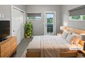 Serene bedroom featuring a large window, closet, and stylish furnishings at 1245 Utica St # 104, Denver, CO 80204