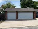 Two-car garage with white doors offers ample parking and storage at 10440 Gilpin St, Northglenn, CO 80233