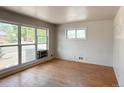 Sunlit living room with hardwood floors and large windows at 10440 Gilpin St, Northglenn, CO 80233