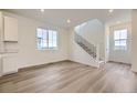 Open-concept living area with lots of light, recessed lights, and staircase at 7321 Waterleaf Trl, Littleton, CO 80125