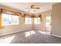 Bright living room with large windows and neutral tones, enhanced by stylish window coverings at 14300 Waterside Ln # L5, Broomfield, CO 80023