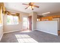 Bright living room featuring neutral paint, carpeted floors, and natural light from a large window at 14300 Waterside Ln # L5, Broomfield, CO 80023
