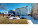 Fenced yard, patio with grill and picnic table, and lawn at 9649 Lansing Cir, Commerce City, CO 80022