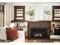 Living room fireplace with brick surround, mantle, and built-in bookshelves at 843 Adams St, Denver, CO 80206