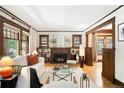 Bright living room boasts hardwood floors, a fireplace, and large windows with wood trim at 843 Adams St, Denver, CO 80206