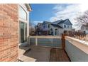 A view of the back patio of the home, with brick accents at 9576 Deerhorn Ct # 50, Parker, CO 80134