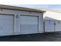 Attached garage for unit 50 with white doors and exterior lighting at 9576 Deerhorn Ct # 50, Parker, CO 80134