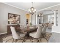 Charming dining room with a wooden table set for six, complemented by neutral chairs and elegant decor at 1328 Double Eagle Ct, Castle Rock, CO 80104