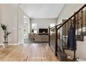 Bright foyer with hardwood flooring, staircase with iron railing, and a glimpse into a neutrally decorated living area at 1328 Double Eagle Ct, Castle Rock, CO 80104