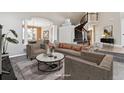 Elegant living room with high ceilings, a curved staircase, and neutral décor at 1328 Double Eagle Ct, Castle Rock, CO 80104