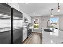 Bright kitchen features stainless steel appliances, a modern faucet, and bright windows offering city views at 2140 S Ash St # 101, Denver, CO 80222