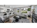 Cozy living room featuring a modern kitchen, fireplace, comfortable seating, and city views at 2140 S Ash St # 101, Denver, CO 80222