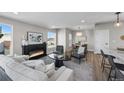 Comfortable living room featuring a fireplace, modern decor, and open layout to the kitchen and dining areas at 2140 S Ash St # 101, Denver, CO 80222
