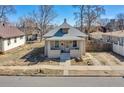 Quaint one story house with covered entryway, small upper window, and dry landscaping at 4710 Pennsylvania St, Denver, CO 80216