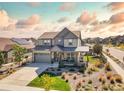 Beautiful two-story home boasts professional landscaping and a welcoming front porch at 8378 Arapahoe Peak St, Littleton, CO 80125