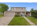 Charming two-story home with a well-maintained lawn and three-car garage at 4650 S Idalia St, Aurora, CO 80015