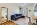 Cozy living room featuring hardwood floors, a comfortable blue sofa, and lots of natural light at 4648 Josephine St, Denver, CO 80216