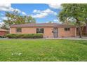Charming brick ranch home with a well-maintained lawn, mature trees, and a cozy, inviting curb appeal at 1330 Oak Pl, Thornton, CO 80229