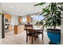 Bright dining area with sliding glass doors, wood table, and seamless flow into kitchen at 848 Sagebrush Dr, Brighton, CO 80603