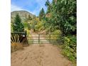 Gated driveway leading to the property, offering privacy and seclusion at 2602 Hidden Valley Road, Sedalia, CO 80135