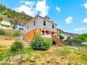 Charming two-story home with gray siding and brick foundation situated on a hillside at 1520 Virginia St, Idaho Springs, CO 80452