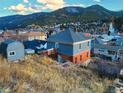 Two-story home with brick foundation and siding is nestled among the mountainside community at 1520 Virginia St, Idaho Springs, CO 80452