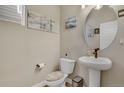 Cozy half bathroom featuring modern fixtures, stylish decor, and ample lighting at 9836 Banner Peak St, Littleton, CO 80125