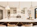 Bright, modern kitchen with marble countertops, stainless steel appliances, and stylish pendant lighting at 2610 N Monroe St, Denver, CO 80205