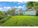 Lush backyard with mature trees and green grass offering a private oasis for outdoor relaxation and recreation at 9465 W 77Th Dr, Arvada, CO 80005