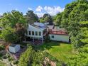 Spacious backyard features a lush lawn, mature trees, a fire pit area, and a storage shed at 9465 W 77Th Dr, Arvada, CO 80005