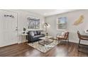 Bright living room featuring hardwood floors, a modern sofa, and natural light at 4729 N Meade St, Denver, CO 80211