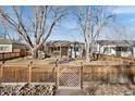 Cozy single-Gathering home with wood fence, rock garden, walkway and mature trees at 1927 Kenton St, Aurora, CO 80010