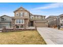 Attractive two-story home with a three-car garage, well-maintained lawn and stone accents on the facade at 17748 W 95Th Ave, Arvada, CO 80007