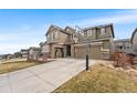 Charming two-story home with a three-car garage and a basketball hoop on a sunny day at 17748 W 95Th Ave, Arvada, CO 80007