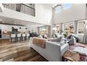 Spacious living room featuring high ceilings, natural light, an open floor plan, and stylish modern decor at 17748 W 95Th Ave, Arvada, CO 80007