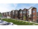 Modern townhomes with mixed brick and siding exterior, individual balconies, and attractive landscaping at 4 Ascent Trl, Englewood, CO 80112