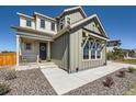 Inviting home exterior featuring a covered porch, stone accents, and a neatly landscaped yard at 6255 Kenzie Cir, Castle Pines, CO 80108