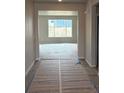 View of the foyer leading into a spacious room with large windows, offering plenty of natural light at 1713 Jennifer St, Brighton, CO 80601