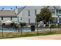 Community pool surrounded by a black fence and lounge chairs for relaxation at 10716 Foxwood Ct, Parker, CO 80138