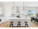 Beautiful kitchen featuring white cabinets, stainless appliances, a kitchen island and adjacent dining area at 5970 S Platte Canyon Dr, Littleton, CO 80123