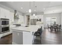 Modern kitchen featuring white cabinetry, stainless steel appliances, and an oversized island at 8803 Antero Ct, Arvada, CO 80007
