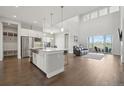 Spacious living room with dark wood floors, an island and a stunning backyard view at 8803 Antero Ct, Arvada, CO 80007
