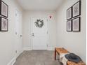 Bright entryway featuring tiled floors, a charming wreath, and decorative city-themed prints at 300 Hudson St # 109, Denver, CO 80220